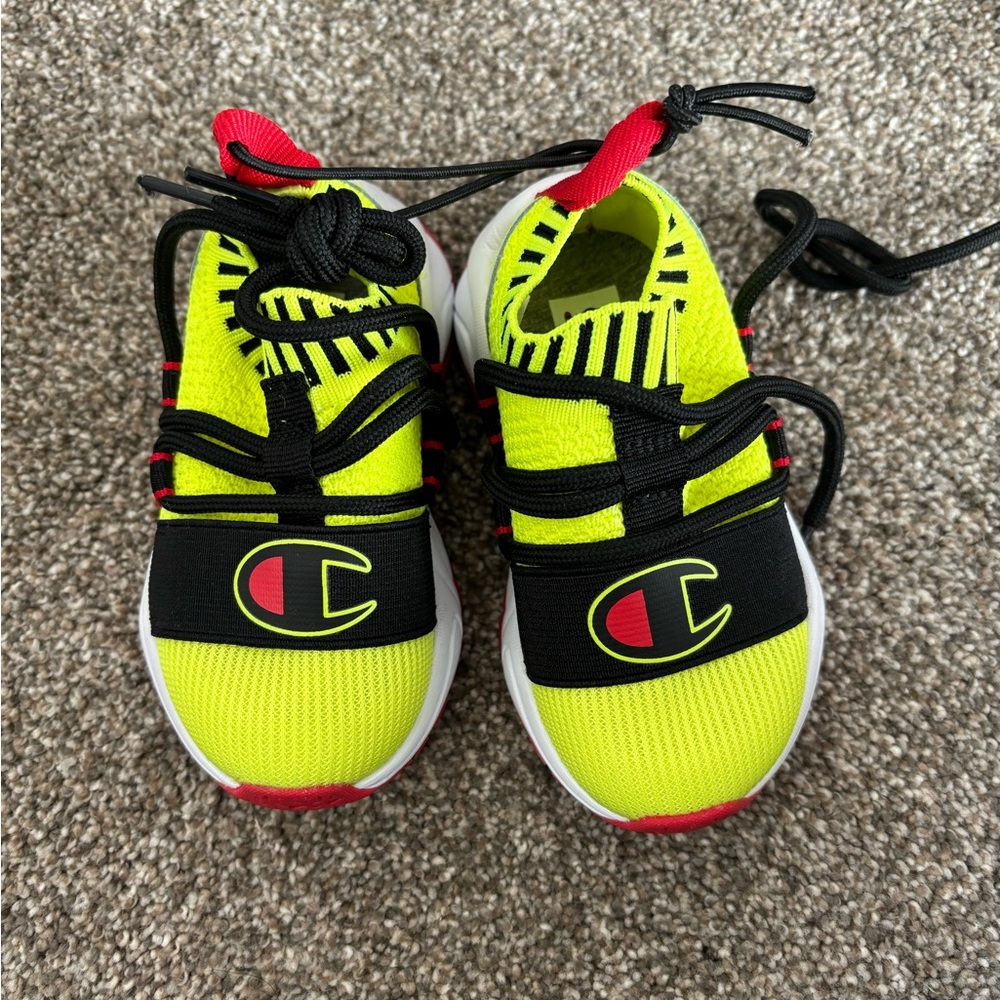 Champions kids shoes. Size 5T . Never worn